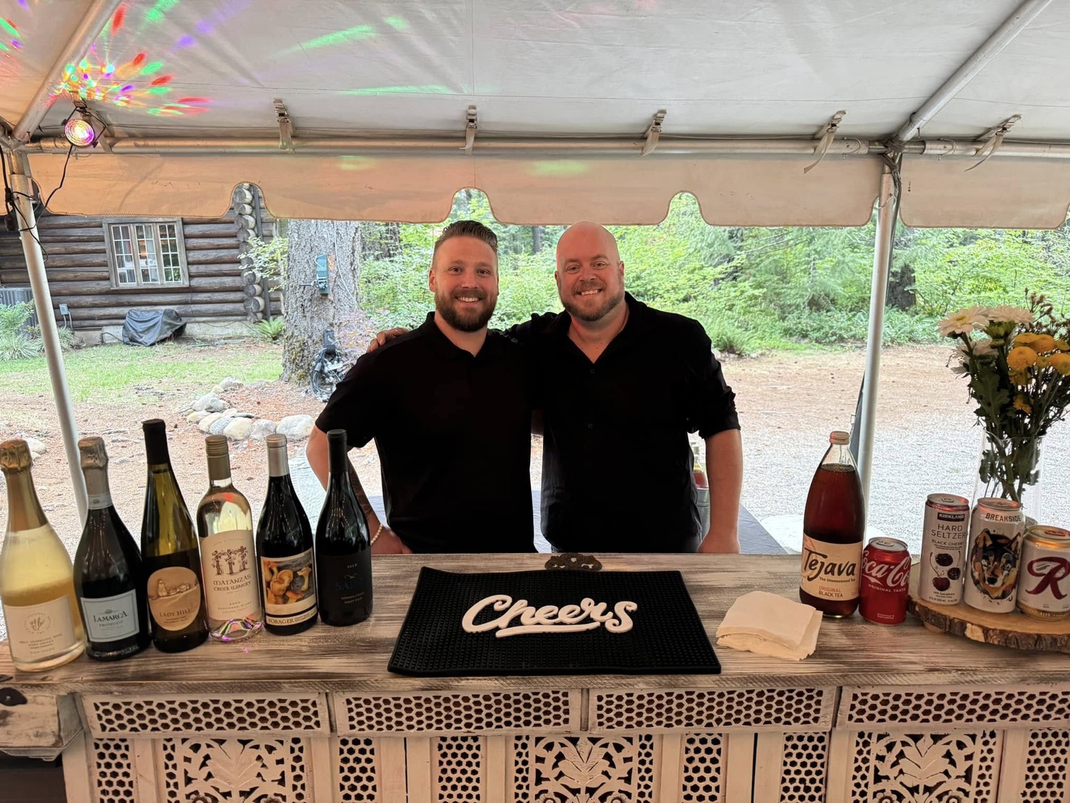 Two Sips mobile bartenders behind a stocked event bar in Central Oregon