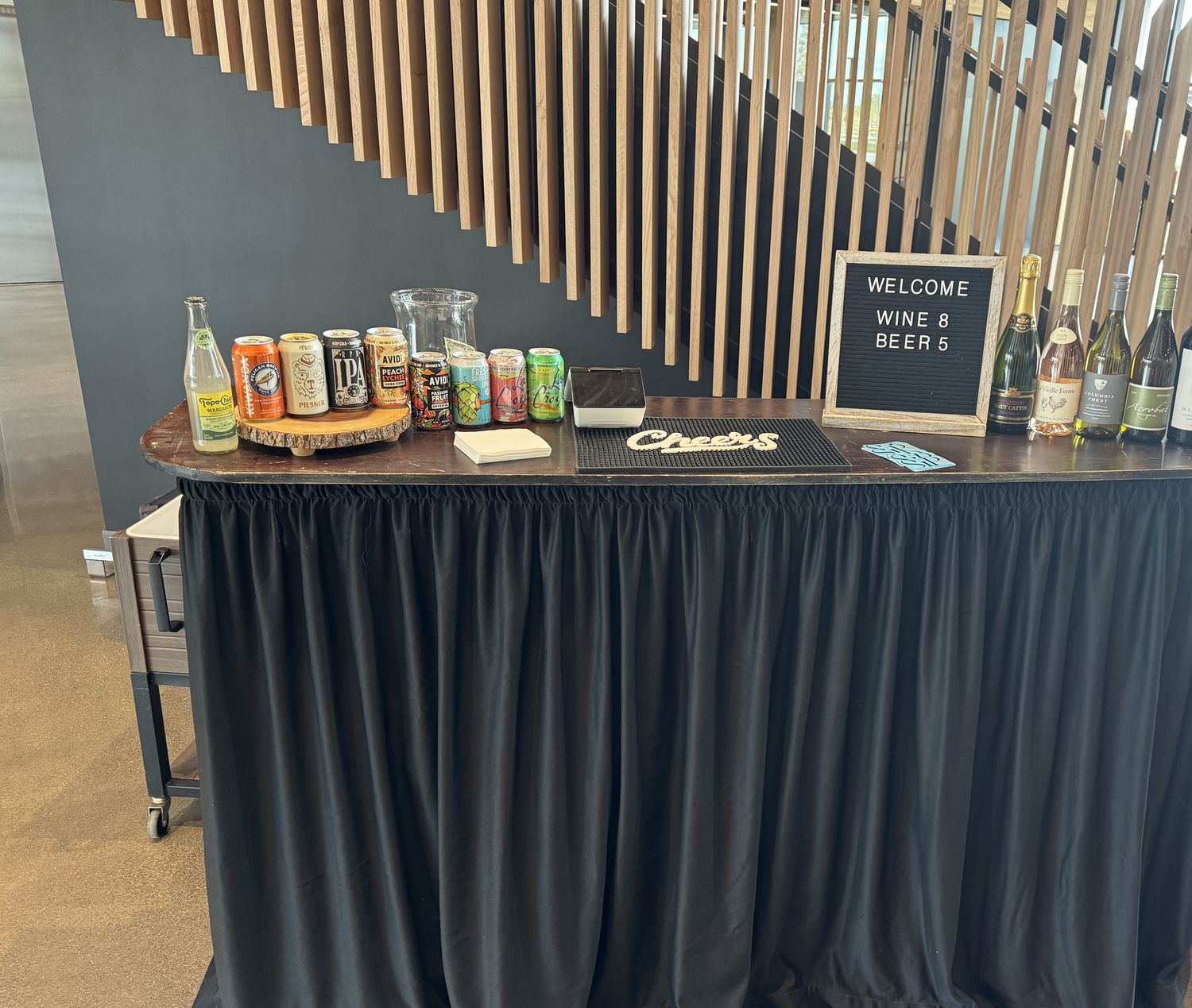 Modern indoor mobile bar setup with beer wine and welcome signage for a Bend Oregon corporate event